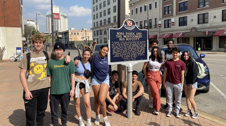 Students pose for a photo during a trip to Alabama