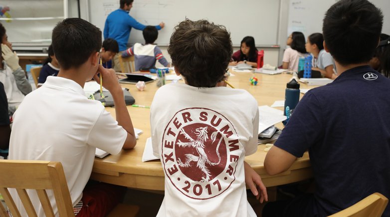 Exeter summer students sitting around a harkness table during math class